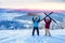 Friends snowboarder and skier standing on mountain top blue sky sunrise. Concept ski resort winter forest