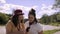 Friends take a selfie in a beautiful park in front of a river.