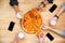 Friends tasting pizza and drinking beer on wooden table