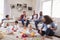 Friends with toddlers playing on the floor in sitting room