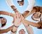 Friends, trust and support hands low angle for solidarity in multicultural group with blue sky. Care, respect and love