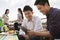 Friends Using Digital Tablet at Rooftop Barbecue