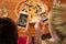 Friends using smartphones to take photos of their pizza