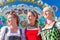 Friends visiting Bavarian fair having fun