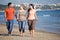 Friends walking along beach