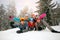 Friends on winter holidays - Skiers lying on snow and having fun