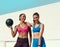 Friends, women and happy with medicine ball for exercise or workout in sportswear, fitness and healthy in New York