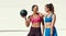 Friends, women and smile with medicine ball for exercise or workout in sportswear, fitness and healthy in New York