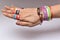 Friendship bands and friendship rings in fingers and wrist.Hand full of friendship bands and rings