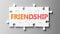 Friendship complex like a puzzle - pictured as word Friendship on a puzzle pieces to show that Friendship can be difficult and