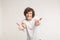 Friendship, cooperation and greeting concept - Smiling curly man in a white t-shirt giving a hands on white background