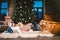Friendship man child and dog pet. Theme Christmas New Year Winter Holidays. Baby boy on the floor decorated tree and best friend