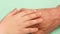 Friendship and support for grandson and grandfather theme. Close-up of a kid`s hand stroking his grandfather`s hand. Caring for th