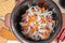 Fries meat with onions and carrots in a multicooker pan. Modern, bright multi cooker with products. Cooking pilaf with meat in