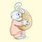 Frightened bunny holds a golden egg before hatching a chicken. Vector