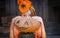 Frightened girl with orange pumpkin
