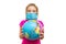 Frightened little girl in a medical mask holds a globe in her hands. Surprised baby eating isolated on a white background. Childre