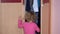 Frightened little girl open closet door and hide inside it. Concept of violence