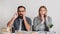 Frightened and shocked man with beard and glasses and with open mouths in workplace