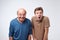 Frightened two men have scared expressions, look nervously, isolated over white background.