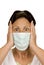 Frightened woman wearing surgical mask
