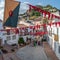 Frigiliana, Malaga, Spain, August 27, 2022: Street view of Frigiliana decorated with a banner and garland on the occasion of the