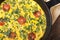 Frittata with green onions, tomatoes in a pan top view