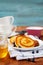 Fritters of cottage cheese with honey, sour cream and bilberry or blueberry on a white plate