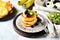 Fritters with honey, banana, blueberries and kiwi on a gray background