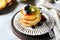 Fritters with honey, banana, blueberries and kiwi on a gray background