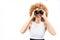 Frizzy-haired gingner girl looking through binoculars