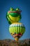 A Frog Hot Air Balloon Hopping Over Another Balloon