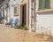 Front of an abandoned house with empty chairs at the entrance