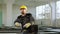 In front of the camera charismatic dancing constructor worker man with safety helmet and uniform while working at