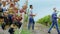 In front of the camera closeup in a large vineyard organic grapes growing walking farmer and his countryside team