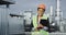 In front of the camera portrait of a African charismatic lady engineer on the rooftop of construction site in helmet