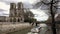 In front of the cathedral Notre Dame de Paris, a excursion boats passes on the seine river.