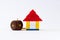 Front close shot of a lego home with cubical wooden keychain and copy space on white background