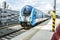 A front close up of a blue and white train numbered 80-30 034-0