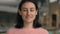 Front close up indoors smiling Caucasian 20s woman student girl looking to camera feel happy smile toothy. Headshot