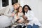 Front close up view of cheerful sick teen girl, her pretty mother and pleasant professional general practitioner