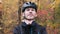 Front close up view of cycling man in black sportswear putting on helmet before training. Young professional triathlete preparing