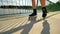 Front close view to inline skates riding on the bridge . Outdoor inline skating on smooth concrete ground on lake bridge.