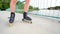 Front close view to inline skates riding on the bridge . Outdoor inline skating on smooth concrete ground on lake bridge.