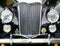 Front detail of a black vintage riley motorcar with bumper headlights radiator and badges