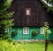 Front detail of traditional mountain cottage, brown and green