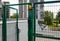 Front door of the courtyard. Metal Wire Fence.Green metal driveway entrance gates