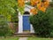 Front door covered with vines and trees