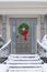 Front door with decorative seasonal or Christmas wreath