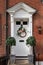 The front door of an English Victorian home with an autumn wreath hanging from the front door